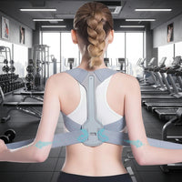 Person wearing a gray posture corrector with a blurred indoor background