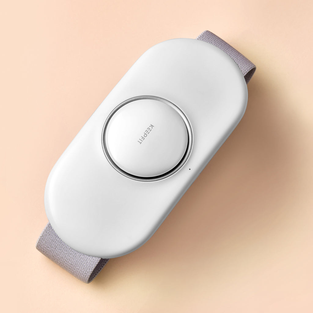White electronic device with gray straps on a beige background