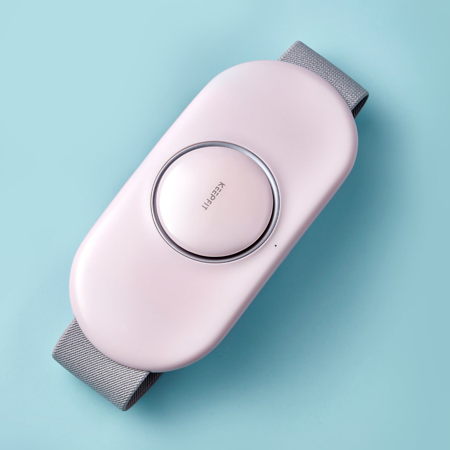 Pink and gray electronic device on a light blue background