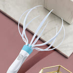 White and blue hairbrush on a pink surface with a beige background