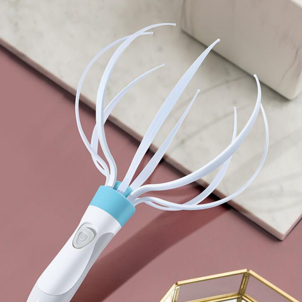 White and blue hairbrush on a pink surface with a beige background