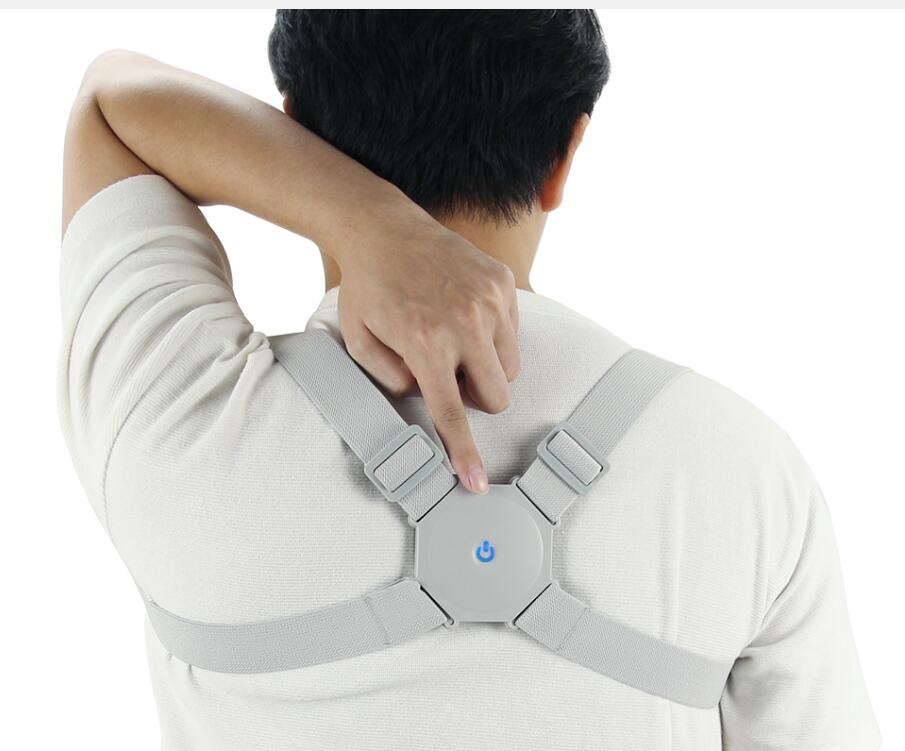 Person wearing a gray posture corrector on a white background