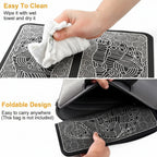 Black and white patterned bag with a hand wiping it and another hand folding it.