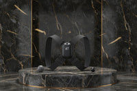Black chest strap device with digital display on a purple platform and background
